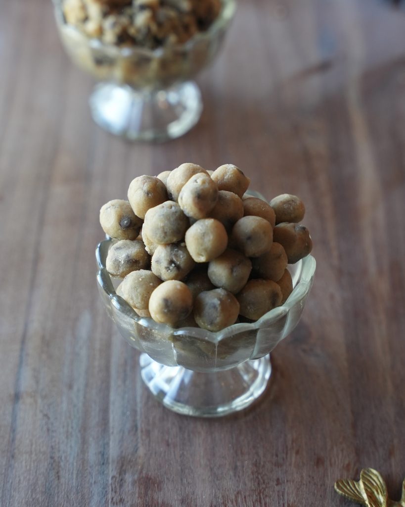 Edible cookie dough bites piled in a glass dessert cup