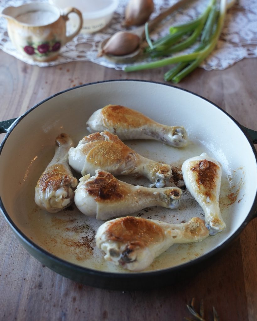 Seared chicken drumsticks in a Dutch oven